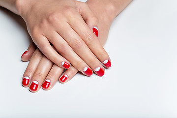 Image showing Female hands with red and white nails