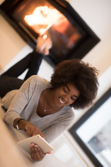 Image showing black women using tablet computer on the floor