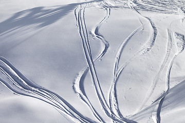 Image showing Off-piste slope with track from ski and snowboard on sunny eveni