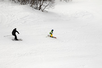 Image showing Skiers on ski slope at winter day