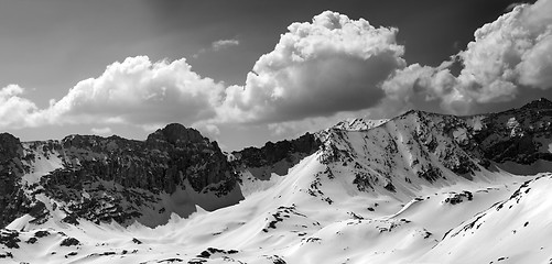 Image showing Black and white panorama of snowy mountains in sun day
