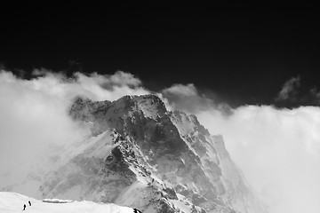 Image showing Black and white view on snow mountains in clouds