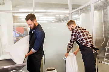 Image showing men with malt bags and mill at craft beer brewery