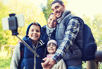 Image showing family with backpacks taking selfie and hiking