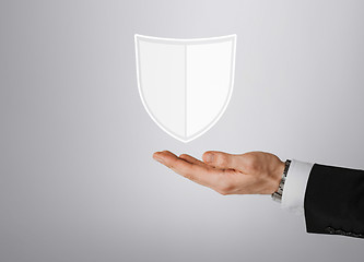 Image showing close up of man with virtual antivirus shield icon