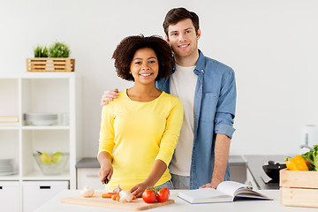 Image showing happy couple cooking food at home kitchen