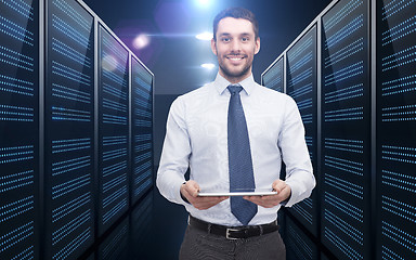 Image showing businessman with tablet pc over server room