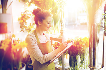 Image showing florist woman with clipboard at flower shop