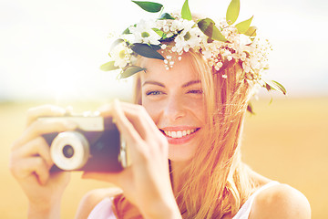 Image showing happy woman with film camera in wreath of flowers