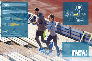 Image showing sporty couple running upstairs on stadium