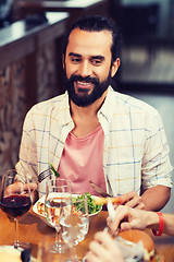 Image showing happy man having dinner at restaurant