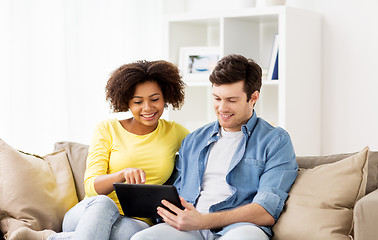 Image showing smiling happy couple with tablet pc at home