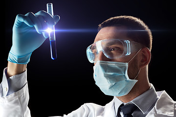 Image showing scientist with safety glasses, mask and test tube