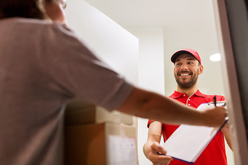 Image showing deliveryman and customer with parcel boxes at home