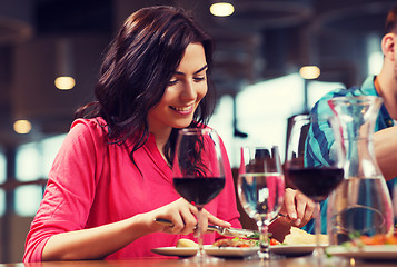 Image showing happy woman having dinner at restaurant