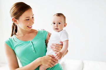 Image showing happy young mother with little baby at home