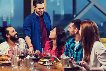 Image showing friends dining and drinking wine at restaurant