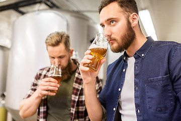 Image showing men drinking and testing craft beer at brewery