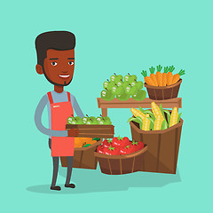 Image showing Supermarket worker with box full of apples.