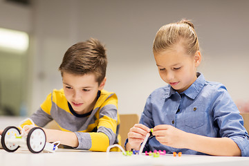 Image showing happy children building robots at robotics school