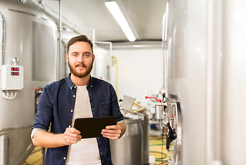 Image showing man with tablet pc at craft brewery or beer plant