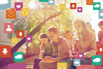 Image showing group of teenage friends with smartphones outdoors