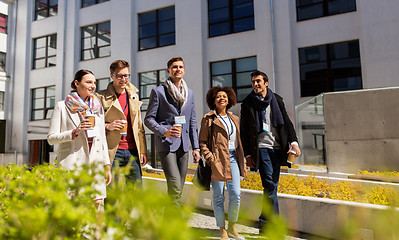 Image showing people with coffee and conference badges in city