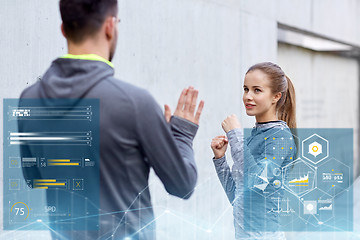 Image showing happy woman with coach working out strike outdoors