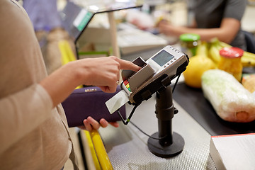 Image showing woman entering pin code at store cash register