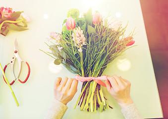 Image showing close up of woman making bunch at flower shop