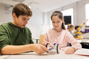 Image showing happy children building robots at robotics school