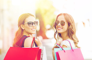 Image showing happy young women with shopping bags in city