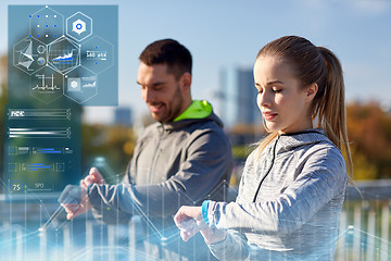 Image showing couple with heart-rate trackers training outdoors