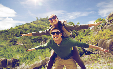 Image showing happy couple with backpacks having fun outdoors