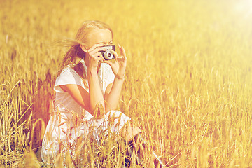 Image showing woman taking picture with camera in cereal field