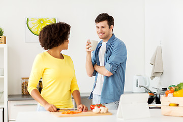 Image showing happy couple cooking food at home kitchen