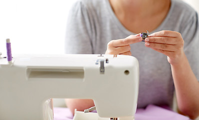 Image showing tailor woman with spool of sewing machine