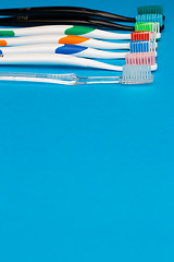 Image showing Multi colored toothbrushes on top
