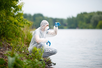 Image showing Ecologist with bulb on river