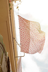 Image showing Bed sheets drying in the street