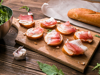 Image showing Wooden cutting board with bacon