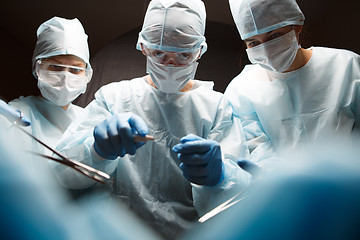 Image showing Photo of surgeons with instruments