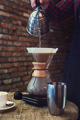 Image showing Barista brewing coffee