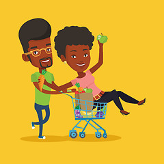 Image showing Couple of friends riding by shopping trolley.