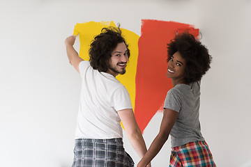 Image showing multiethnic couple painting interior wall