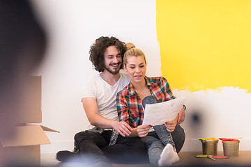 Image showing Happy young couple relaxing after painting