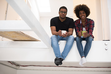 Image showing couple having break during moving to new house