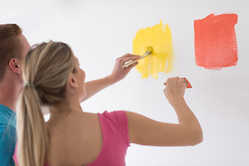 Image showing couple painting interior wall