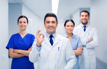 Image showing group of medics at hospital showing ok hand sign