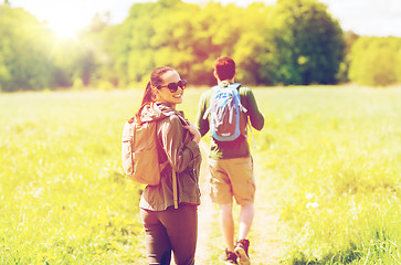 Image showing happy couple with backpacks hiking outdoors